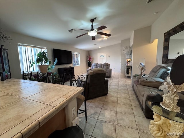 1481 E Topaz Cir Unit 2, Fort Mohave, AZ 86426 - living area with vaulted ceiling, light tile patterned floors, visible vents, and ceiling fan
