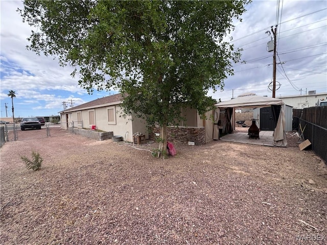 1481 E Topaz Cir Unit 2, Fort Mohave, AZ 86426 - rear view of property featuring a fenced backyard, a gazebo, and stucco siding