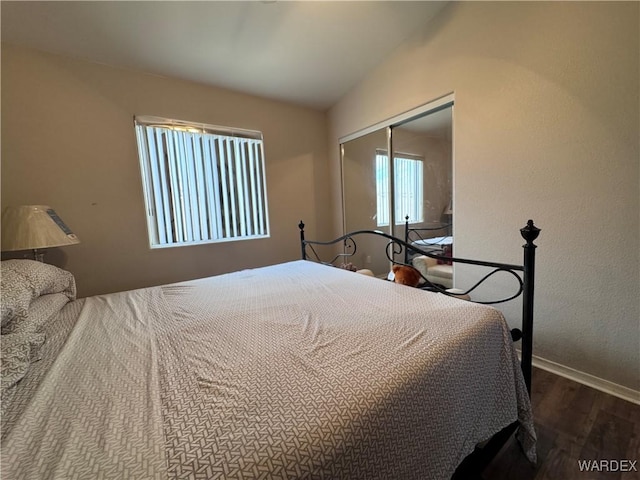 1481 E Topaz Cir Unit 2, Fort Mohave, AZ 86426 - bedroom with baseboards, vaulted ceiling, a closet, and wood finished floors
