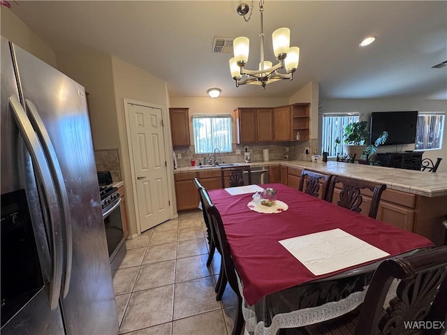 1481 E Topaz Cir Unit 2, Fort Mohave, AZ 86426 - dining room featuring a chandelier, light tile patterned flooring, a healthy amount of sunlight, and visible vents