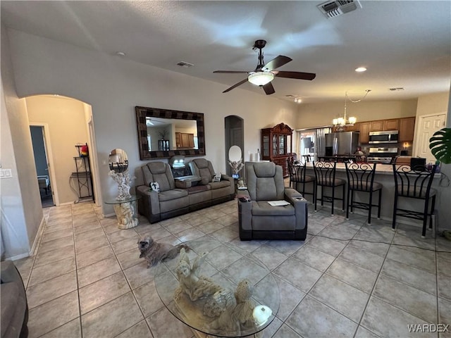 1481 E Topaz Cir Unit 2, Fort Mohave, AZ 86426 - living room featuring light tile patterned floors, visible vents, a ceiling fan, and arched walkways