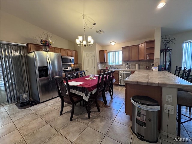 1481 E Topaz Cir Unit 2, Fort Mohave, AZ 86426 - dining area featuring a chandelier, light tile patterned floors, visible vents, and a healthy amount of sunlight