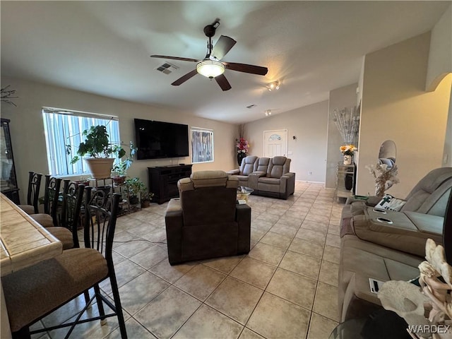 1481 E Topaz Cir Unit 2, Fort Mohave, AZ 86426 - living room with light tile patterned floors, visible vents, lofted ceiling, and a ceiling fan