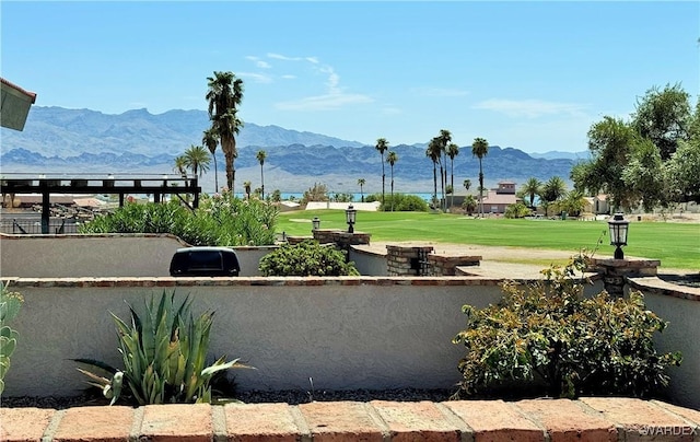 view of home's community with a yard and a mountain view