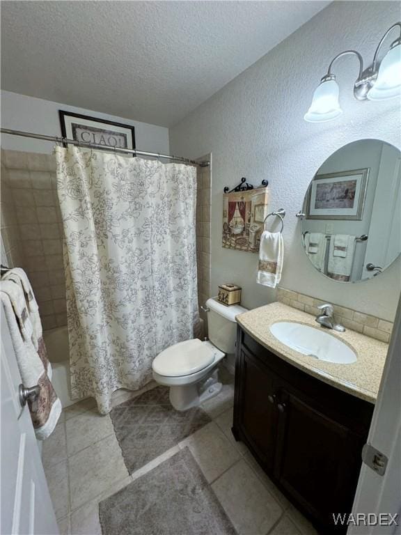 bathroom with toilet, tile patterned floors, shower / bathtub combination with curtain, a textured ceiling, and vanity