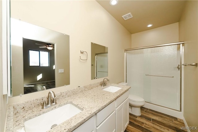 full bathroom with toilet, a sink, visible vents, and wood tiled floor