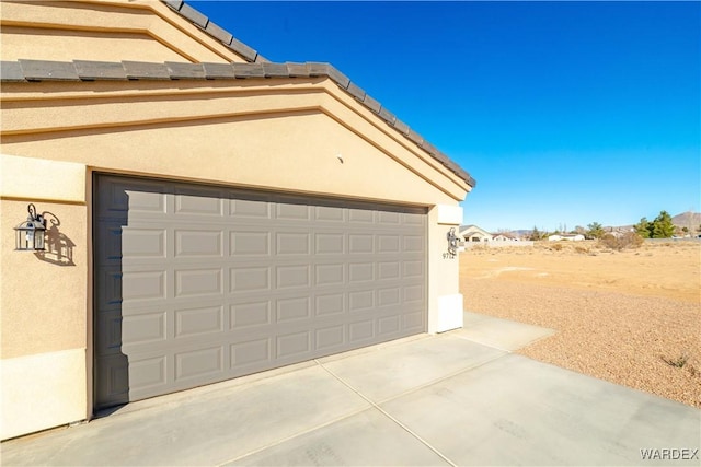 garage with concrete driveway