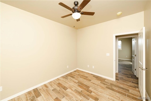 empty room with light wood-type flooring, ceiling fan, and baseboards