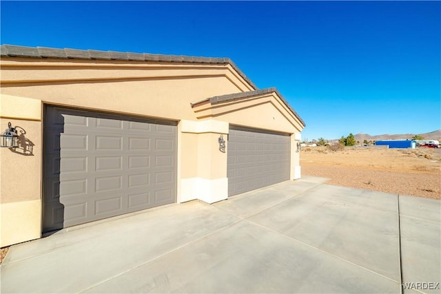 garage with concrete driveway