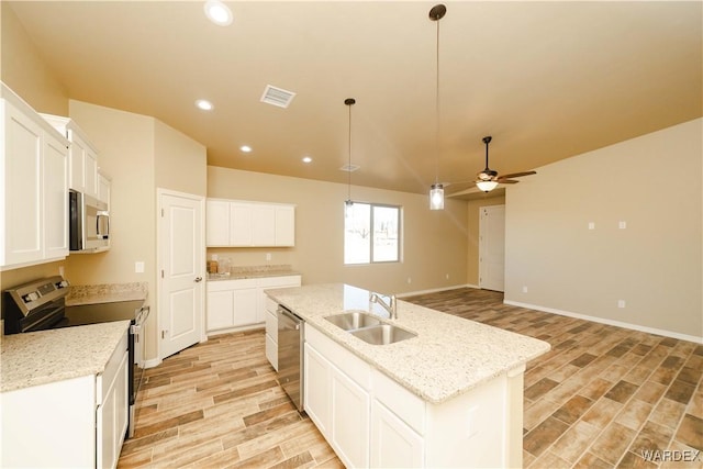 kitchen with stainless steel appliances, a ceiling fan, wood tiled floor, a sink, and an island with sink