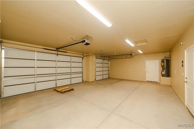 garage with water heater and a garage door opener