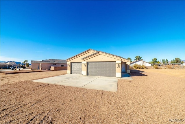 garage with concrete driveway