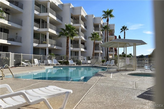 view of swimming pool featuring a patio area and fence