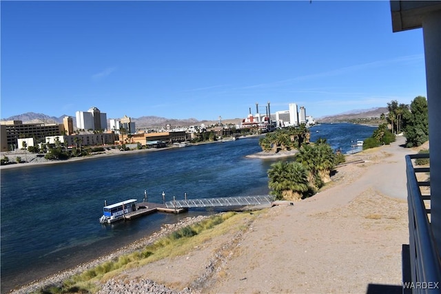 property view of water featuring a boat dock and a mountain view