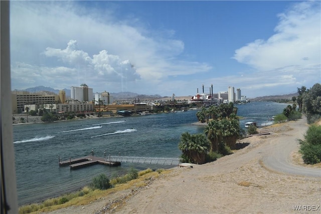 view of water feature featuring a dock and a city view