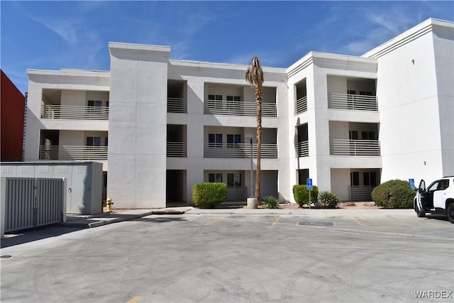 view of building exterior featuring uncovered parking