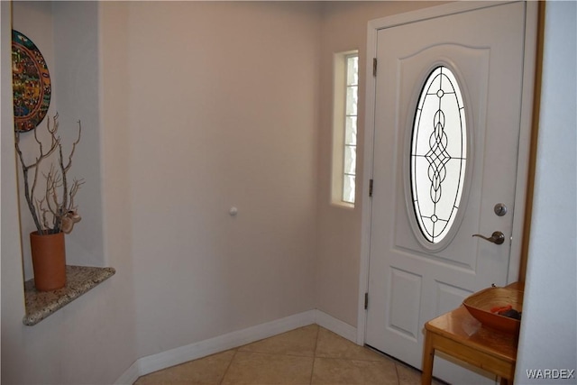 foyer with baseboards and light tile patterned flooring