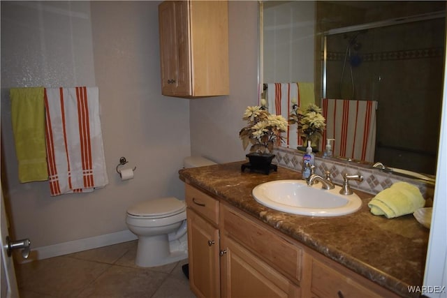 bathroom featuring tile patterned flooring, toilet, vanity, baseboards, and a shower stall