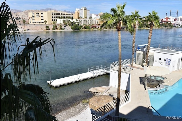 dock area with a water view and a community pool