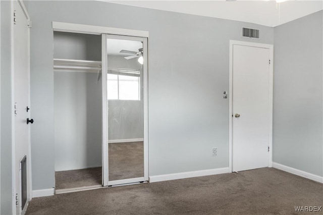 unfurnished bedroom with carpet floors, a closet, visible vents, and baseboards