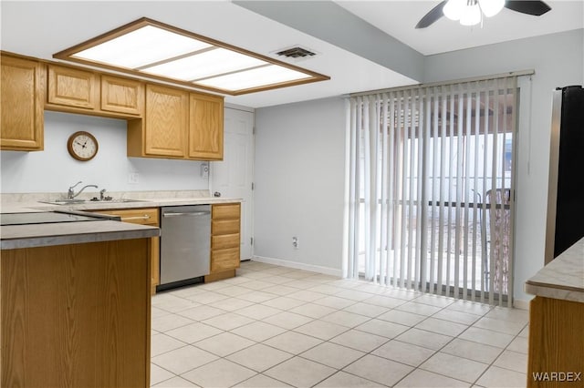 kitchen with light countertops, appliances with stainless steel finishes, a sink, and visible vents