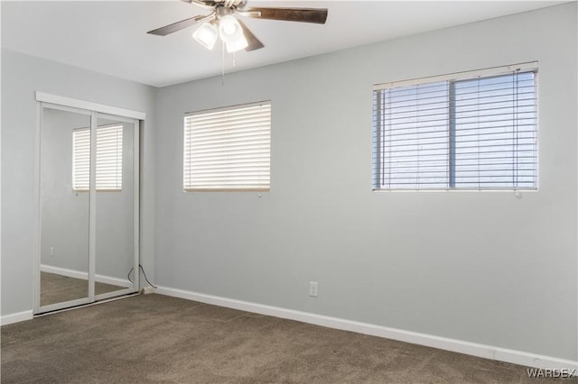 unfurnished bedroom with a closet, carpet flooring, and baseboards