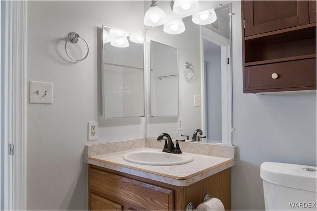 half bath featuring toilet and vanity