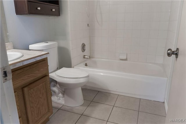 full bath featuring washtub / shower combination, tile patterned flooring, vanity, and toilet