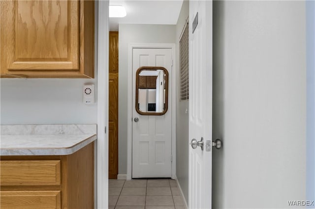 hall with light tile patterned floors