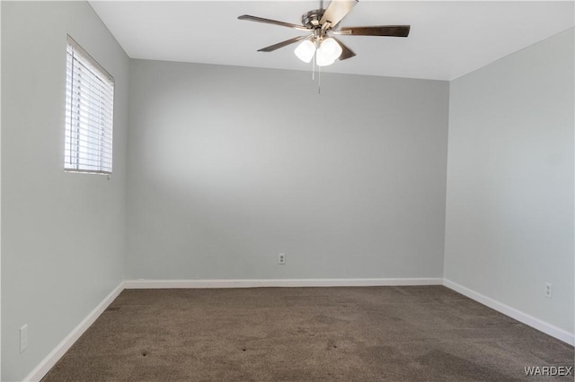 spare room with ceiling fan, baseboards, and carpet flooring