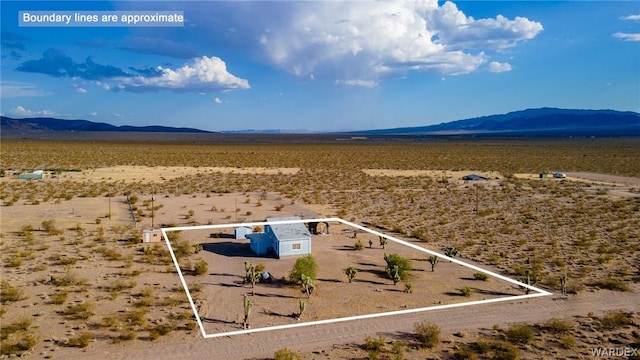 drone / aerial view featuring a desert view and a mountain view