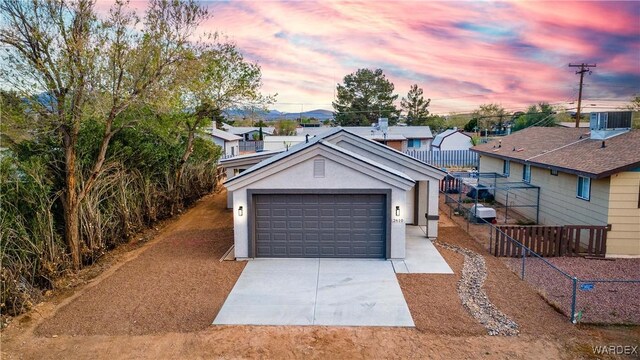 detached garage featuring central AC unit and fence