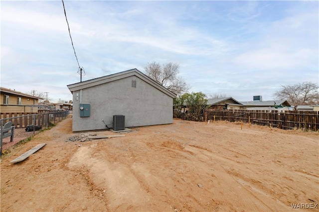 exterior space with fence and central air condition unit