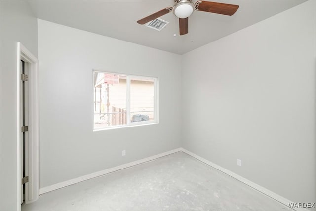 spare room featuring concrete flooring, ceiling fan, visible vents, and baseboards