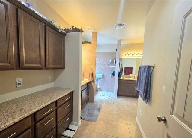4132 Monte Silvano Ct, Kingman, AZ 86401 - full bathroom featuring two vanities, tiled shower, and tile patterned floors