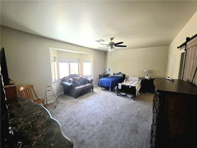 4132 Monte Silvano Ct, Kingman, AZ 86401 - carpeted bedroom featuring a barn door and a ceiling fan