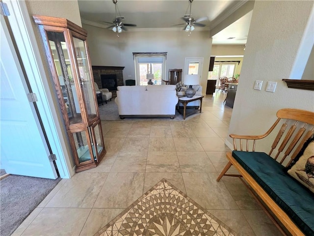 4132 Monte Silvano Ct, Kingman, AZ 86401 - living area featuring ornamental molding, a ceiling fan, a fireplace, and light tile patterned floors