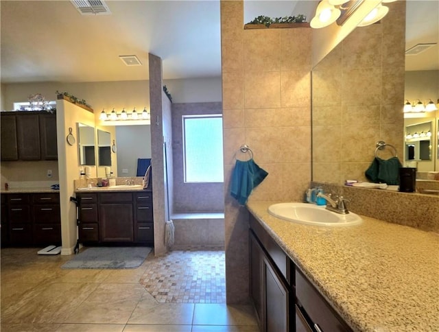 4132 Monte Silvano Ct, Kingman, AZ 86401 - bathroom featuring two vanities, tile patterned flooring, and a tile shower