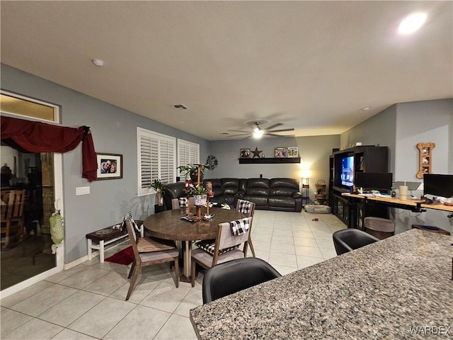 dining room with light tile patterned floors and ceiling fan