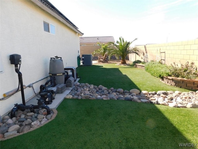 view of yard featuring a fenced backyard and central AC