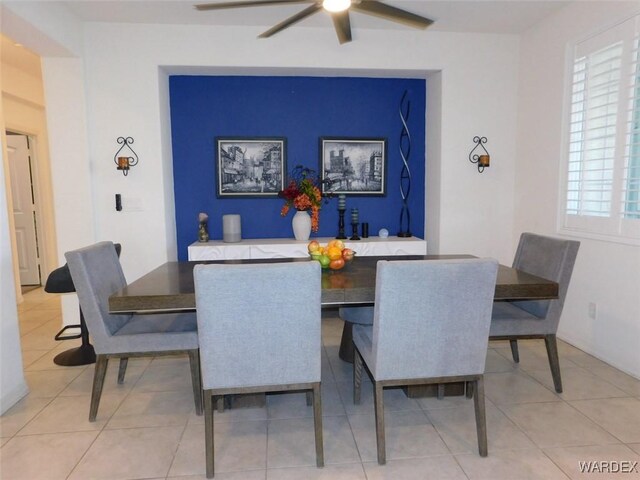 dining space with light tile patterned floors and ceiling fan