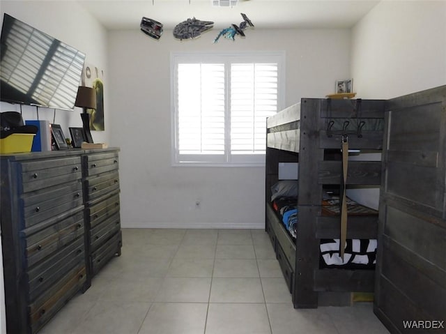 bedroom with light tile patterned floors, visible vents, and baseboards