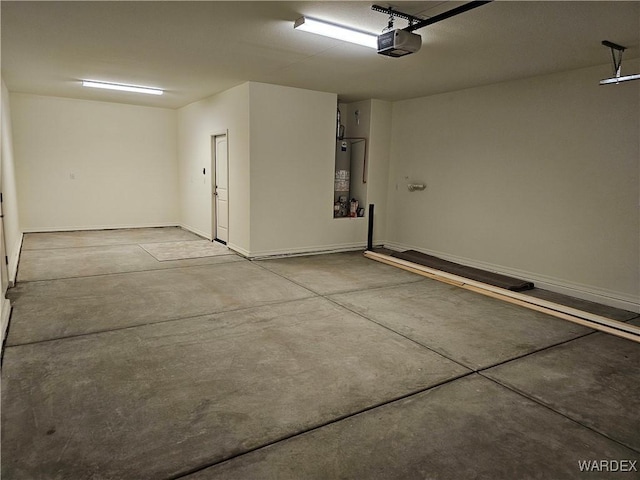 garage featuring gas water heater and a garage door opener