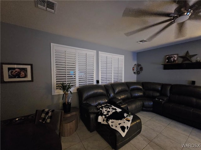 living room featuring ceiling fan, visible vents, and light tile patterned flooring