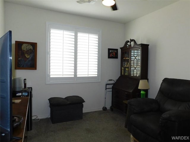 living area with carpet flooring and ceiling fan