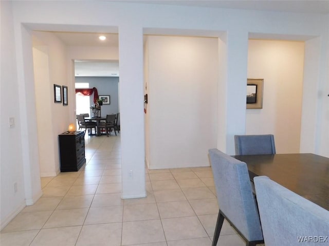 dining room featuring baseboards and light tile patterned floors