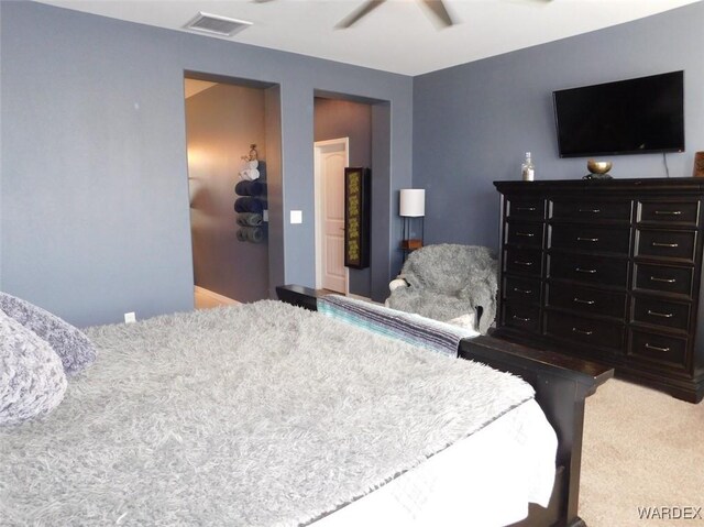 bedroom with ceiling fan, visible vents, and carpet flooring