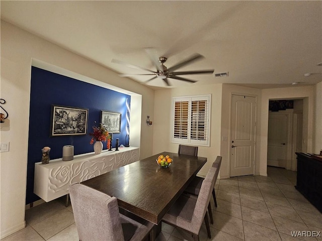 dining space with light tile patterned floors, ceiling fan, visible vents, and baseboards