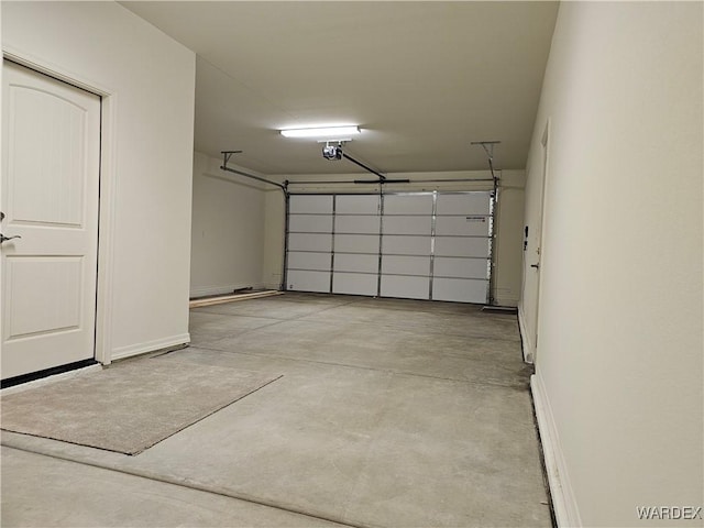 garage featuring baseboards and a garage door opener