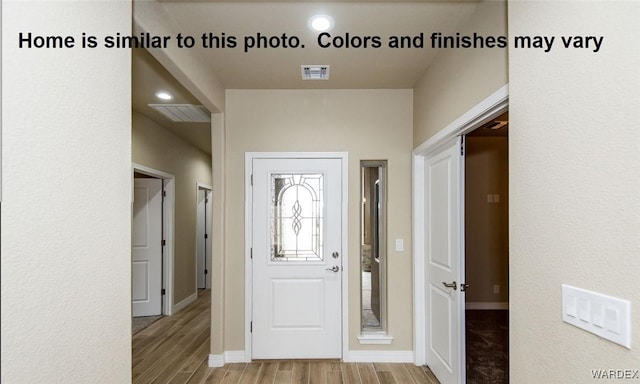 foyer entrance featuring recessed lighting, wood finished floors, visible vents, and baseboards